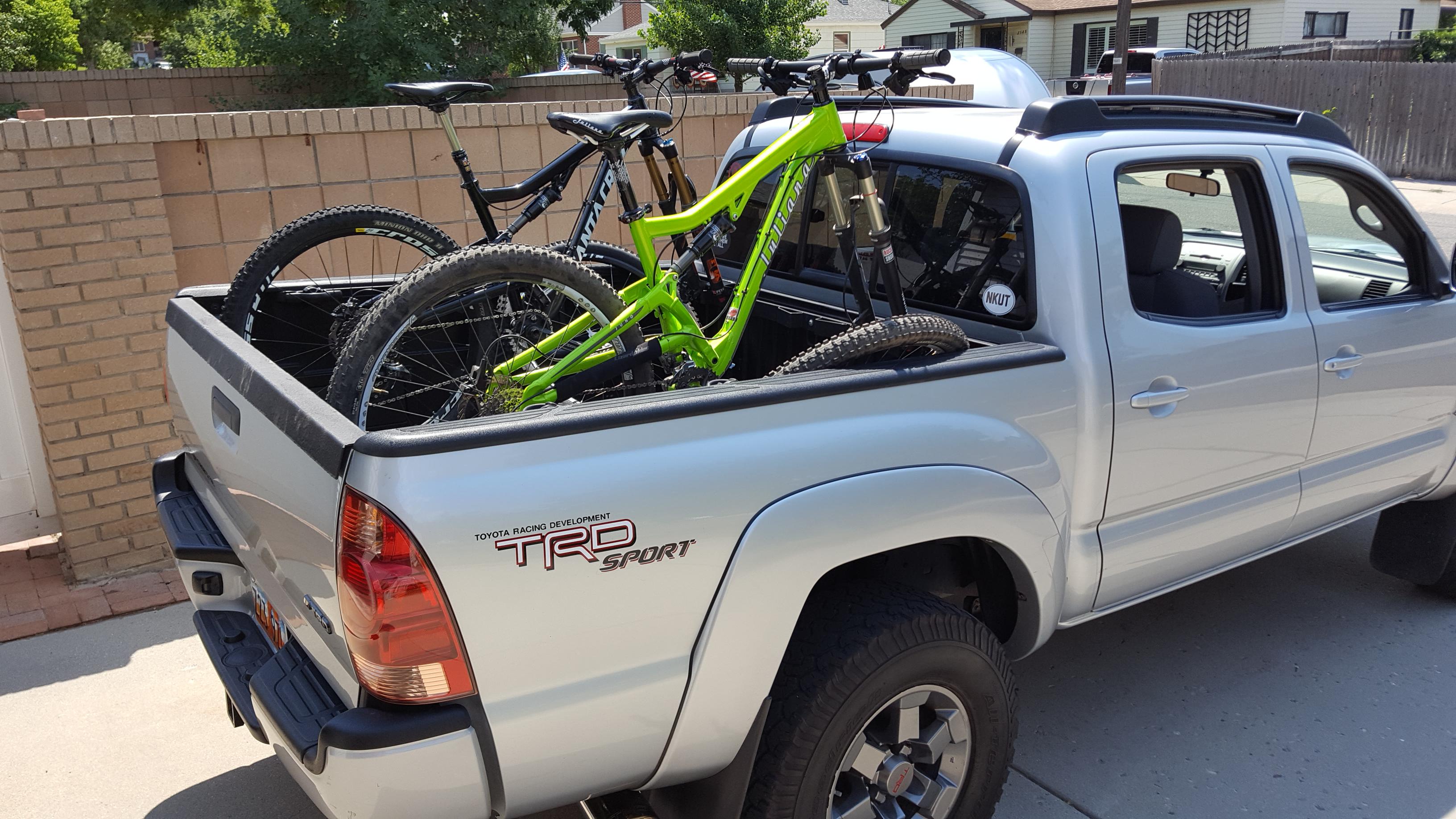 mountain bikes in the back of a pickup